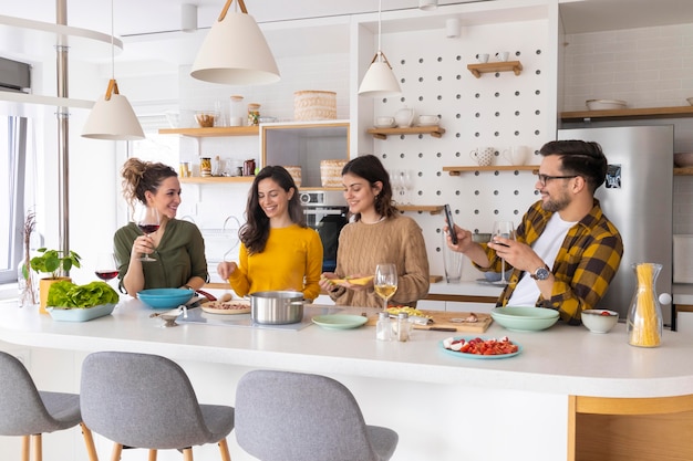 Grupo de amigos preparando a refeição na cozinha