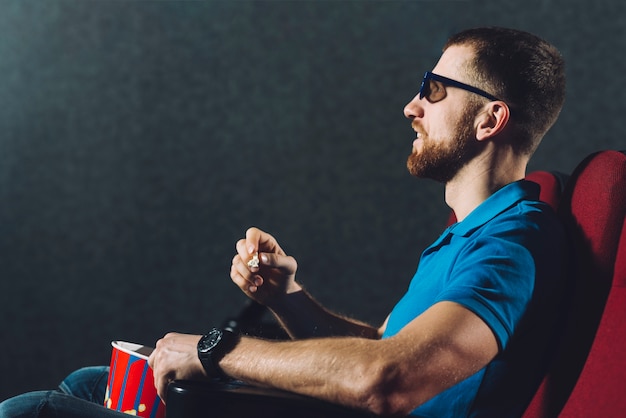 Foto grátis homem barbudo assistindo filme no cinema