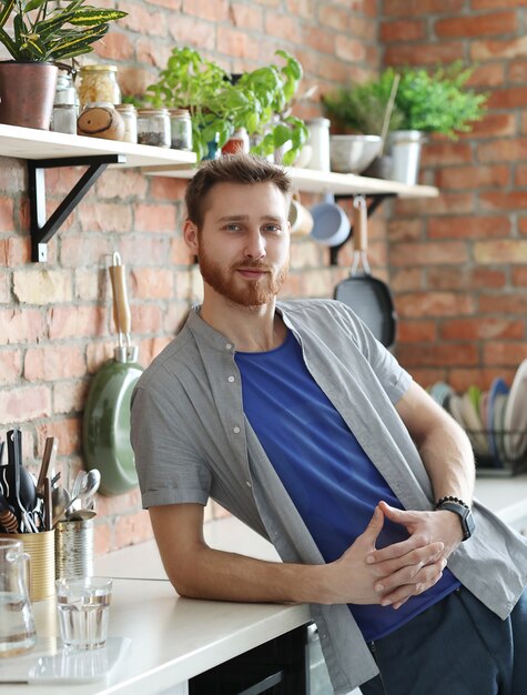 Homem bonito, posando na cozinha