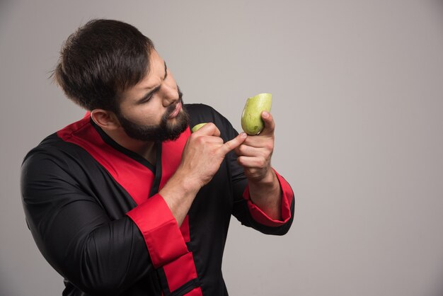 Homem com barba aparecendo na abobrinha cortada pela metade.