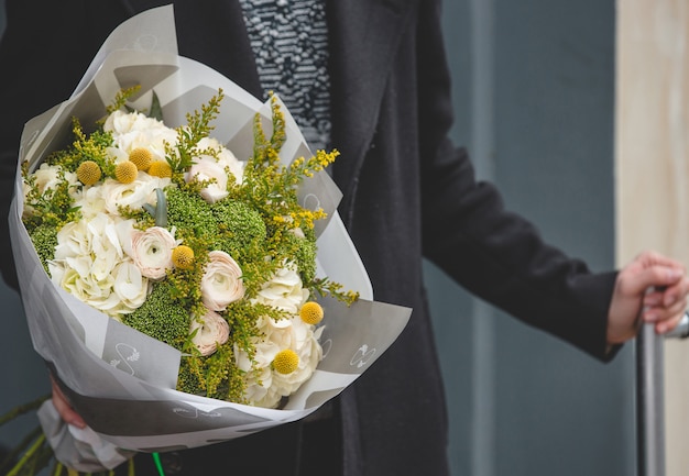 Foto grátis homem com um buquê branco de rosas