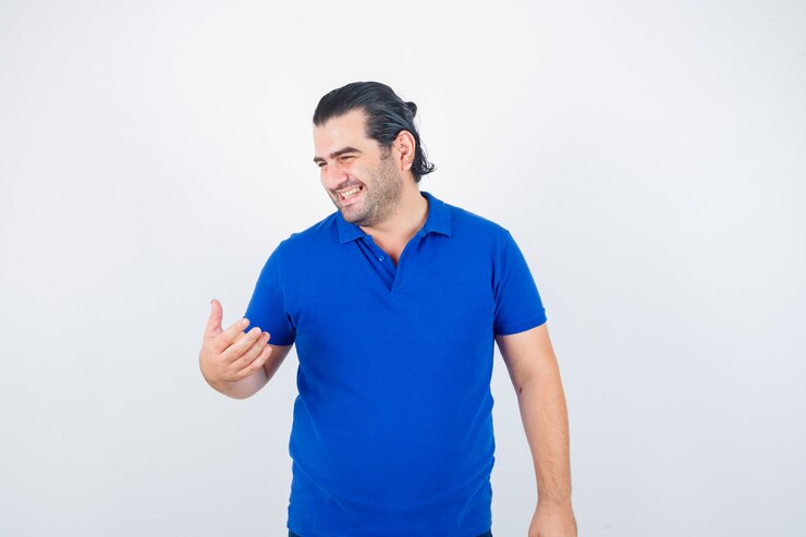 Foto grátis homem de meia idade olhando para o outro lado com camiseta azul e aparência alegre