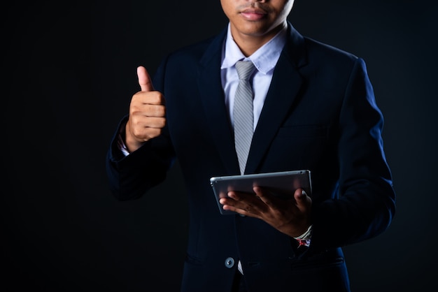 Homem de negócios usando tablet analisando dados de vendas e gráfico de crescimento econômico, tecnologia