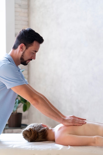 Homem de tiro médio massageando as costas