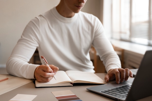 Homem de vista frontal trabalhando com laptop