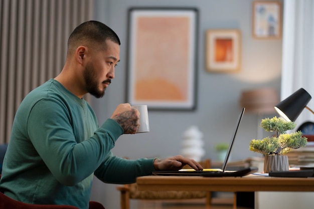 Homem de vista lateral trabalhando em casa