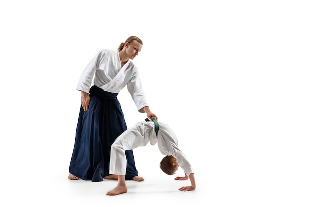 Foto grátis homem e menino adolescente lutando no treinamento de aikido na escola de artes marciais