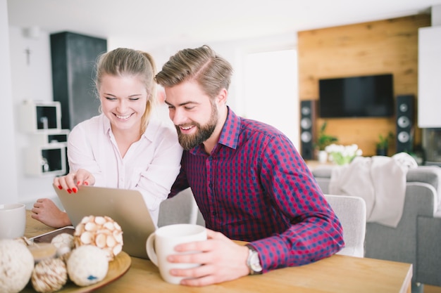 Foto grátis homem e mulher alegre usando o laptop