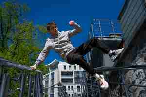 Foto grátis homem em forma de tiro completo fazendo parkour