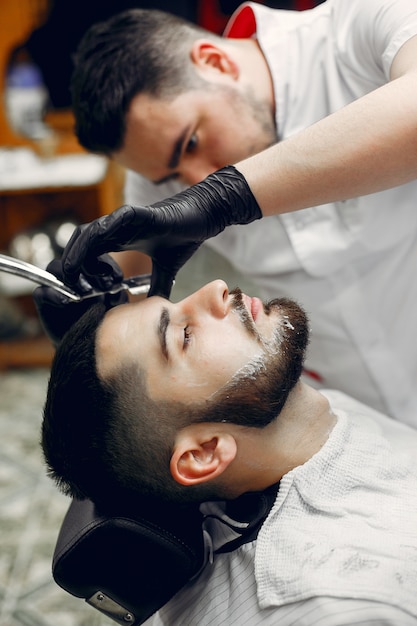 Homem estiloso sentado em uma barbearia