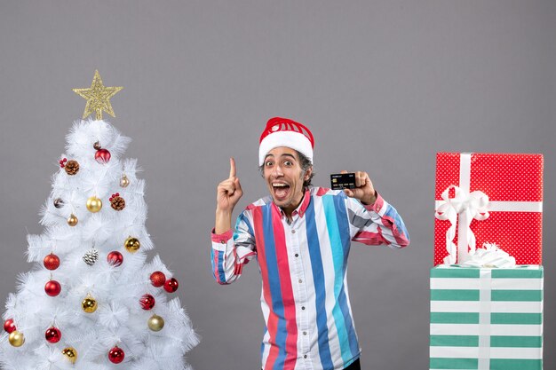 Homem feliz de vista frontal apontando o dedo mostrando algo