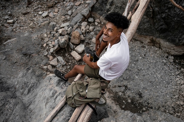 Foto grátis homem feliz sentado sobre troncos