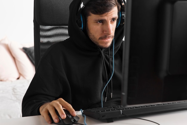 Homem jogando jogo no computador, tiro médio