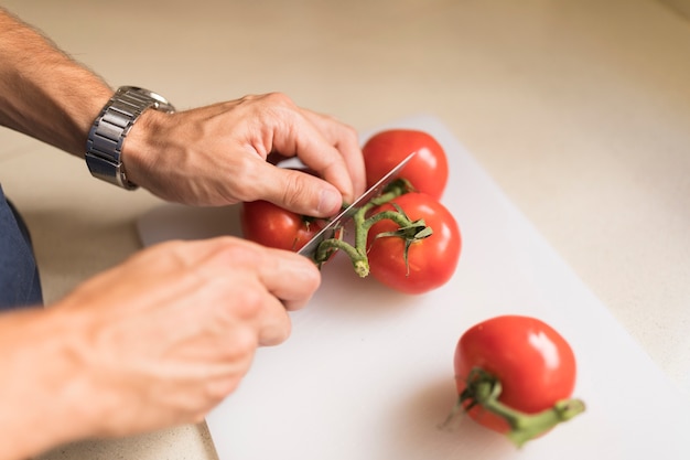 Homem, mão, corte, tomates, ligado, tábua cortante