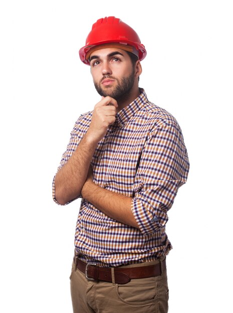 Homem pensativo com um capacete vermelho