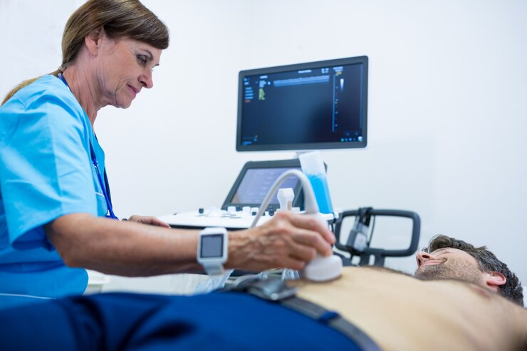 Foto grátis homem que começ o ultra-som de um abdômen de médico