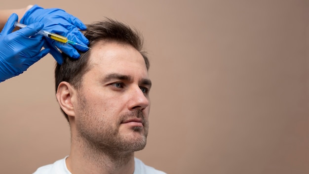 Foto grátis homem recebendo injeção de prp para alopecia