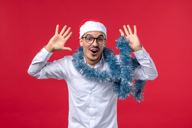 Homem regular de vista frontal comemorando ano novo na parede vermelha feriado humano de natal