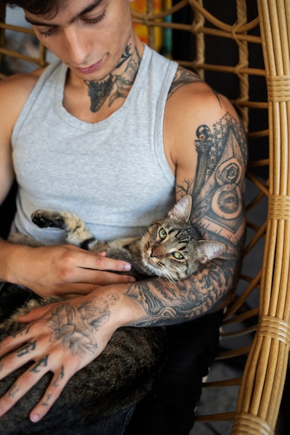 Foto grátis homem segurando gato fofo alto ângulo