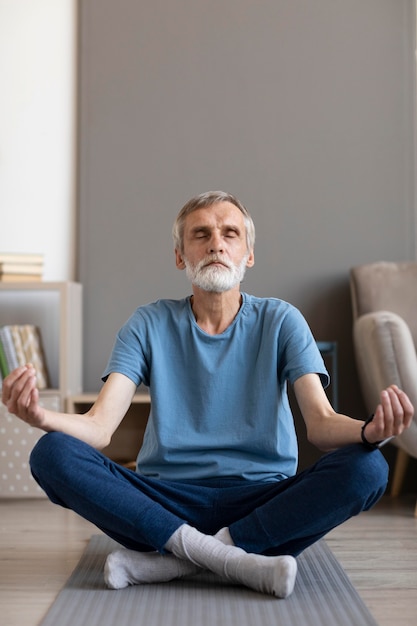 Homem sênior meditando de frente