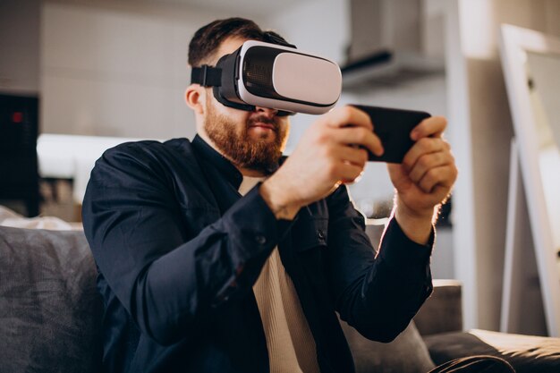 Homem sentado em casa usando vr