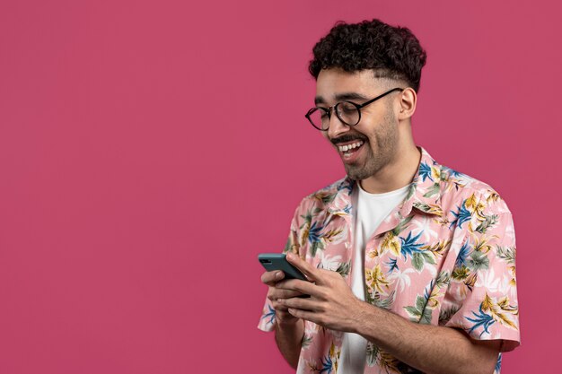 Homem sorridente de tiro médio segurando smartphone