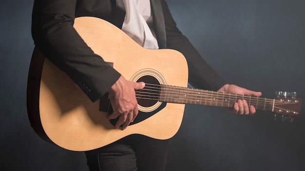 Homem tocando violão, tiro médio