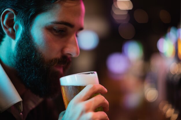 Homem tomando um copo de cerveja