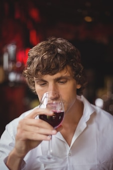 Homem tomando uma taça de vinho tinto