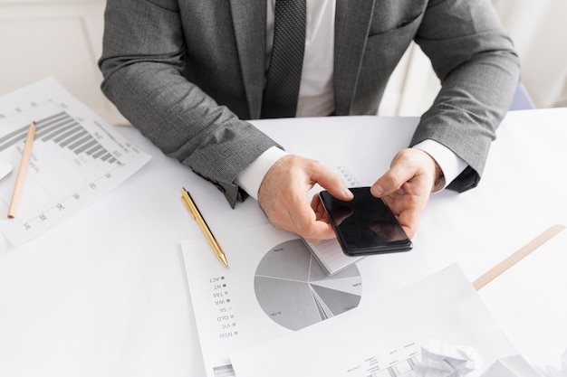 Homem verificando seu telefone no trabalho