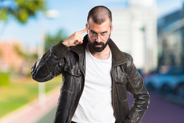 Foto grátis homem vestindo uma jaqueta de couro pensando