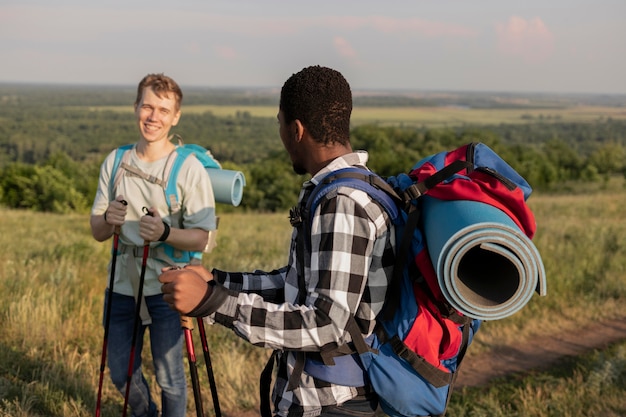 Homens tiro médio com mochilas