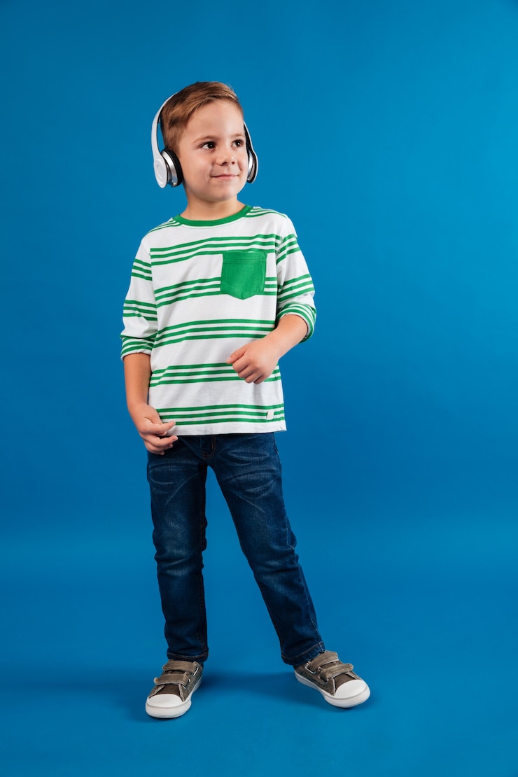 Foto grátis imagem completa de um menino alegre ouvindo música