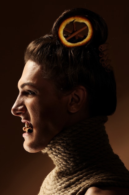 Imagem criativa com laranja e canela em um penteado