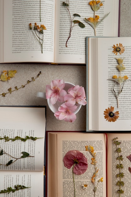 Foto grátis imprensa de flores de vista superior com livros