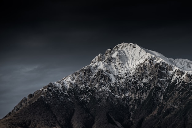 Incrível fotografia em preto e branco de belas montanhas e colinas com céu escuro