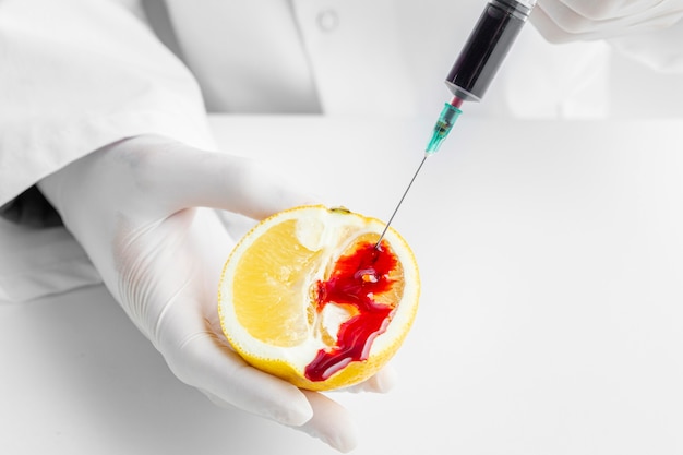 Injetando produtos químicos em um citros com seringa