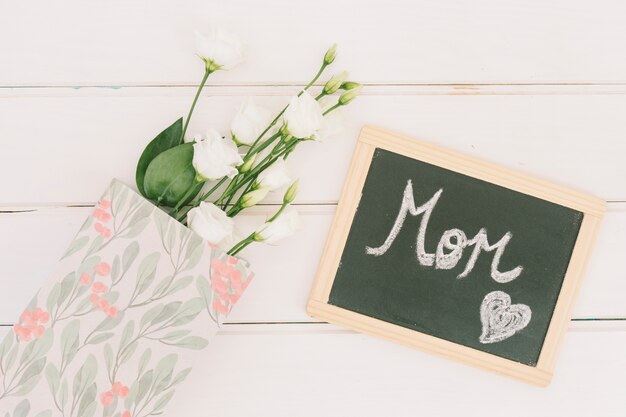 Inscrição de mãe no quadro-negro com rosas