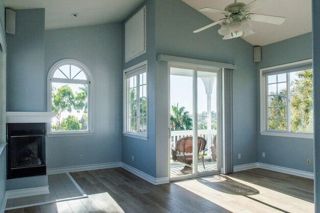 Interior moderno e moderno de uma sala de estar com paredes azuis e janelas brancas