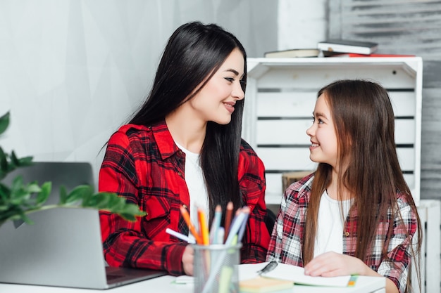 Irmã, o que você está fazendo Duas meninas fazendo lição de casa em casa