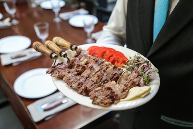 Iskender doner grelhado carne tomate queijo cebola com verdes vista lateral