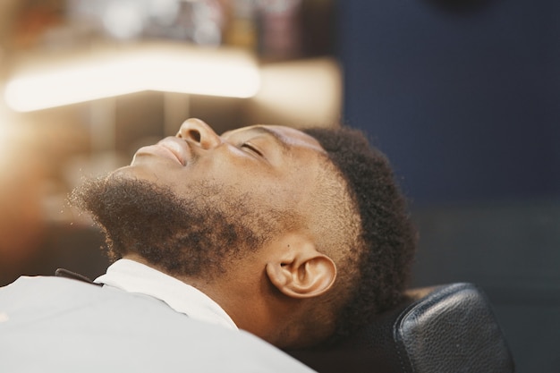 Jovem afro-americano visitando uma barbearia