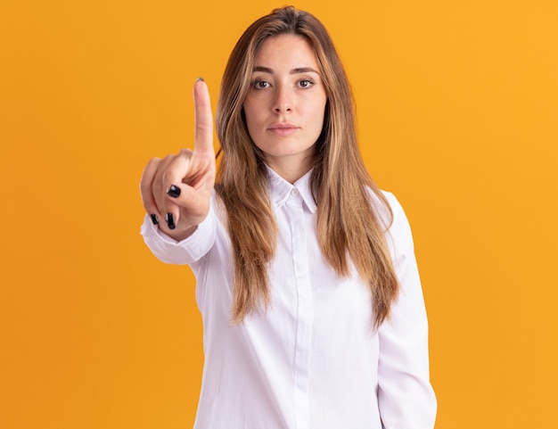 Jovem bonita caucasiana confiante mostrando o dedo indicador