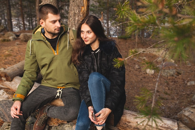 Jovem bonito hipster homem e mulher apaixonada viajando juntos na natureza selvagem, caminhando na floresta