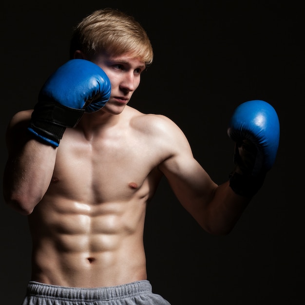 Jovem boxeador bonito em um movimento