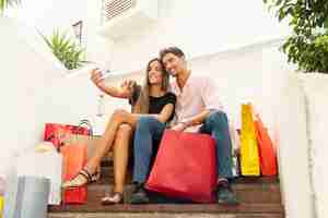 Foto grátis jovem casal de compras tomando selfies