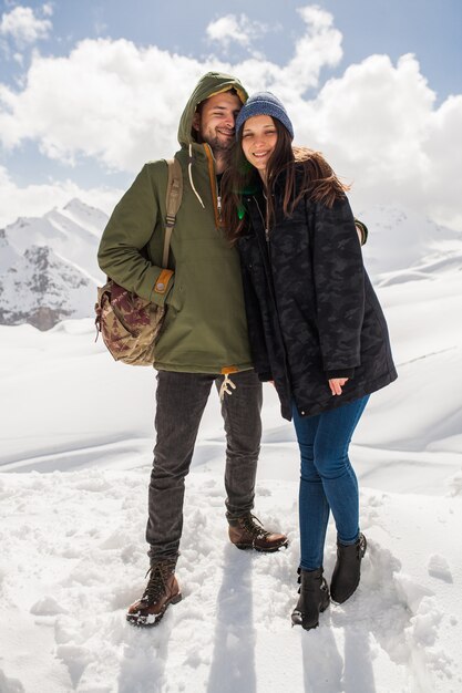 Jovem casal lindo hippie caminhando nas montanhas, viagem de férias de inverno, homem, mulher