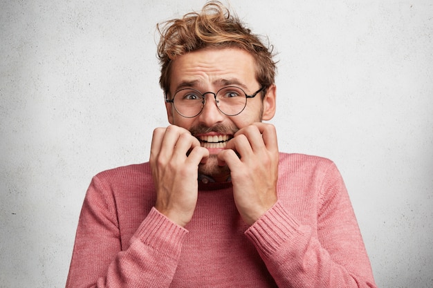 Jovem com barba e óculos redondos