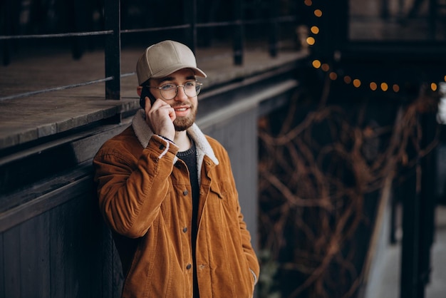 Jovem com casaco usando telefone