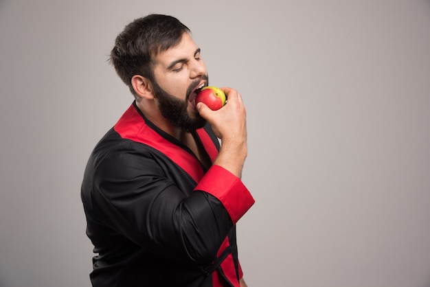 Foto grátis jovem comendo uma maçã fresca.